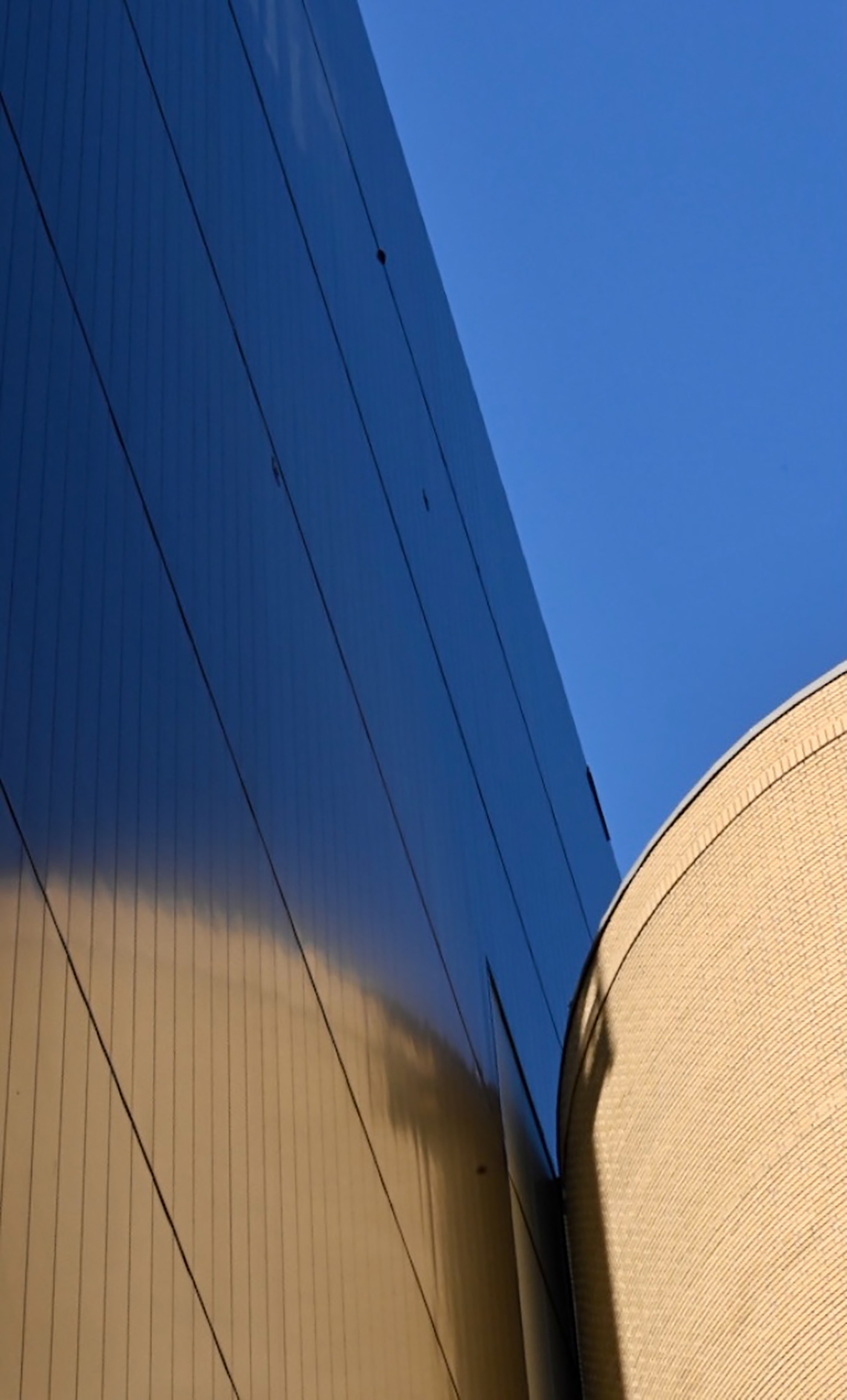 Geometric building facade against a blue sky 