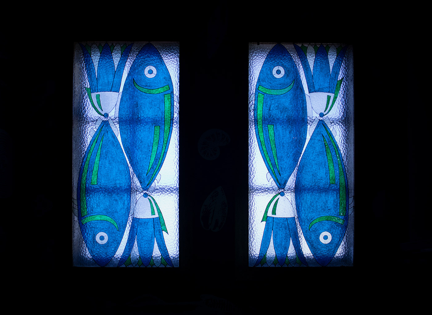 Two stained glass windows with fish motifs