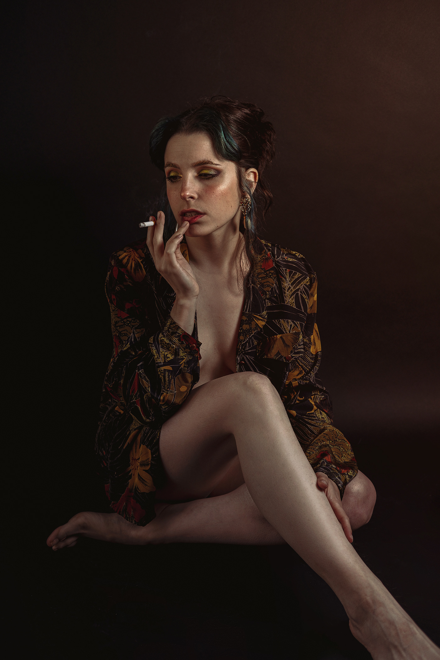 Portrait photography of a girl smoking cigarette in studio with black background and flash
