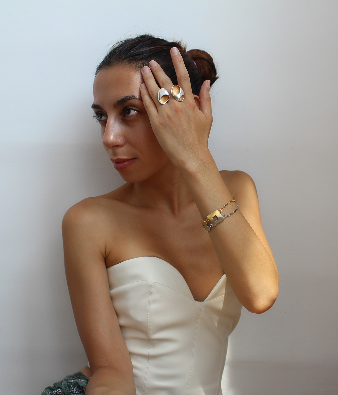 adorable woman is wearing high fashion silver and gold jewelry from made in love