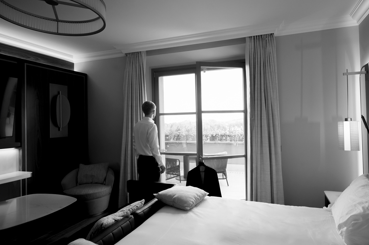indoor, wall and window, groom black and white, watching outdoor. Castelfalfi resort.
