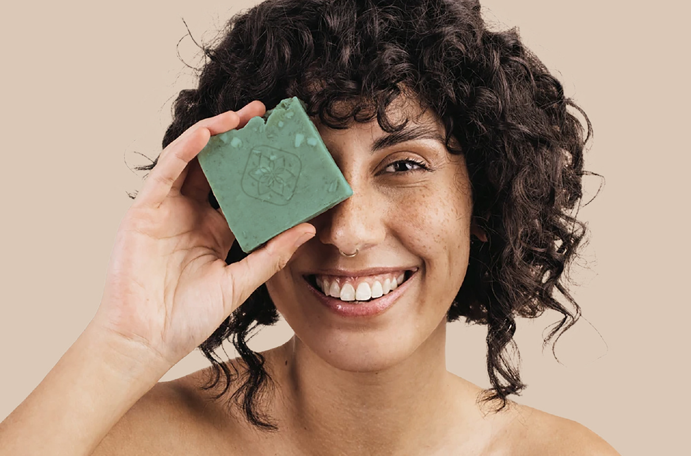 woman smiles with handmade soap