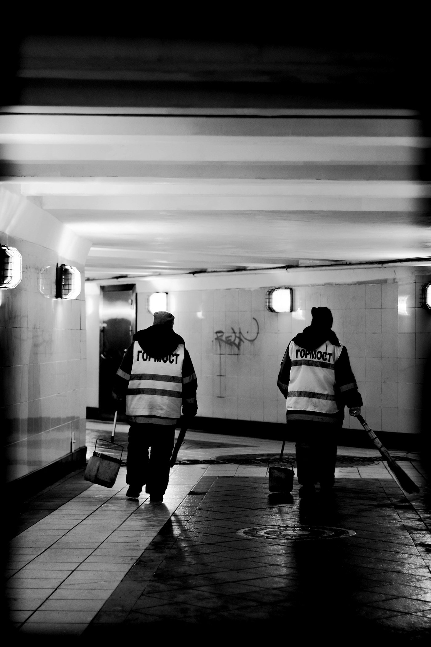 black and white street photography city blur light dark black White underground crossing Passersby