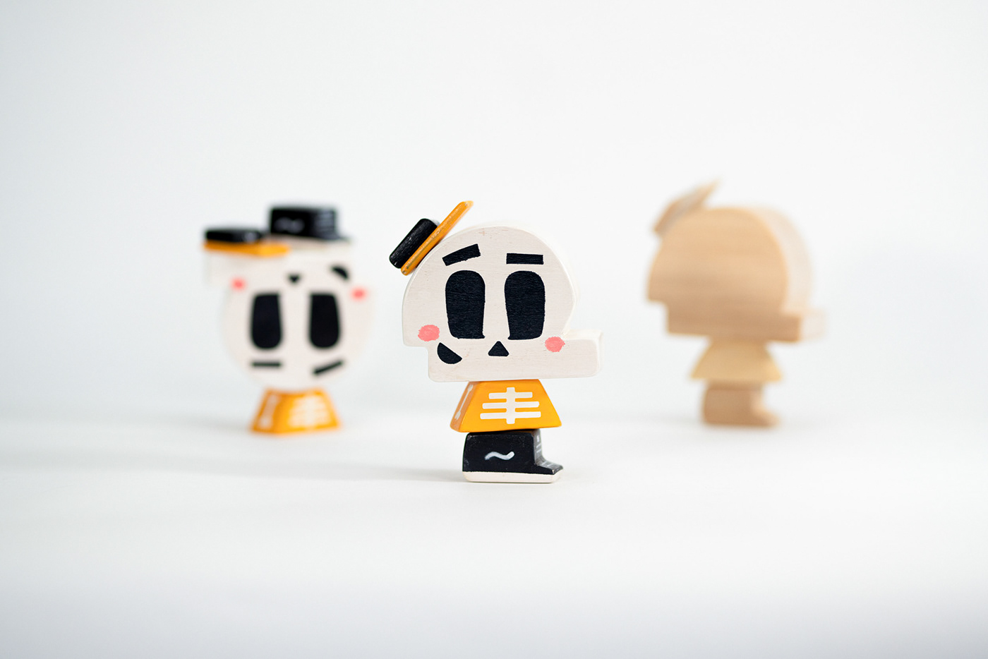 skully center stage as a wooden block toy with two other versions in the background.