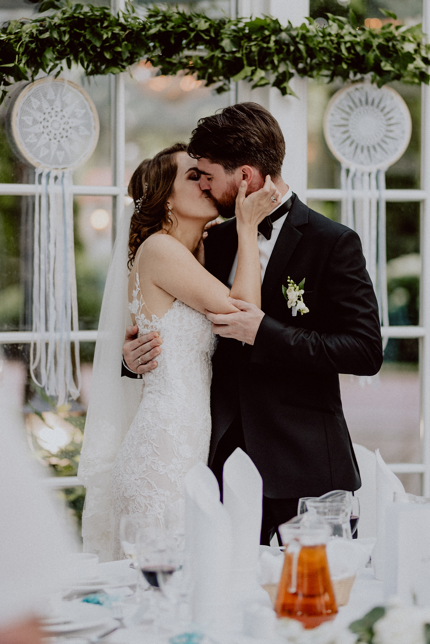 Image may contain: wedding dress, bride and kiss