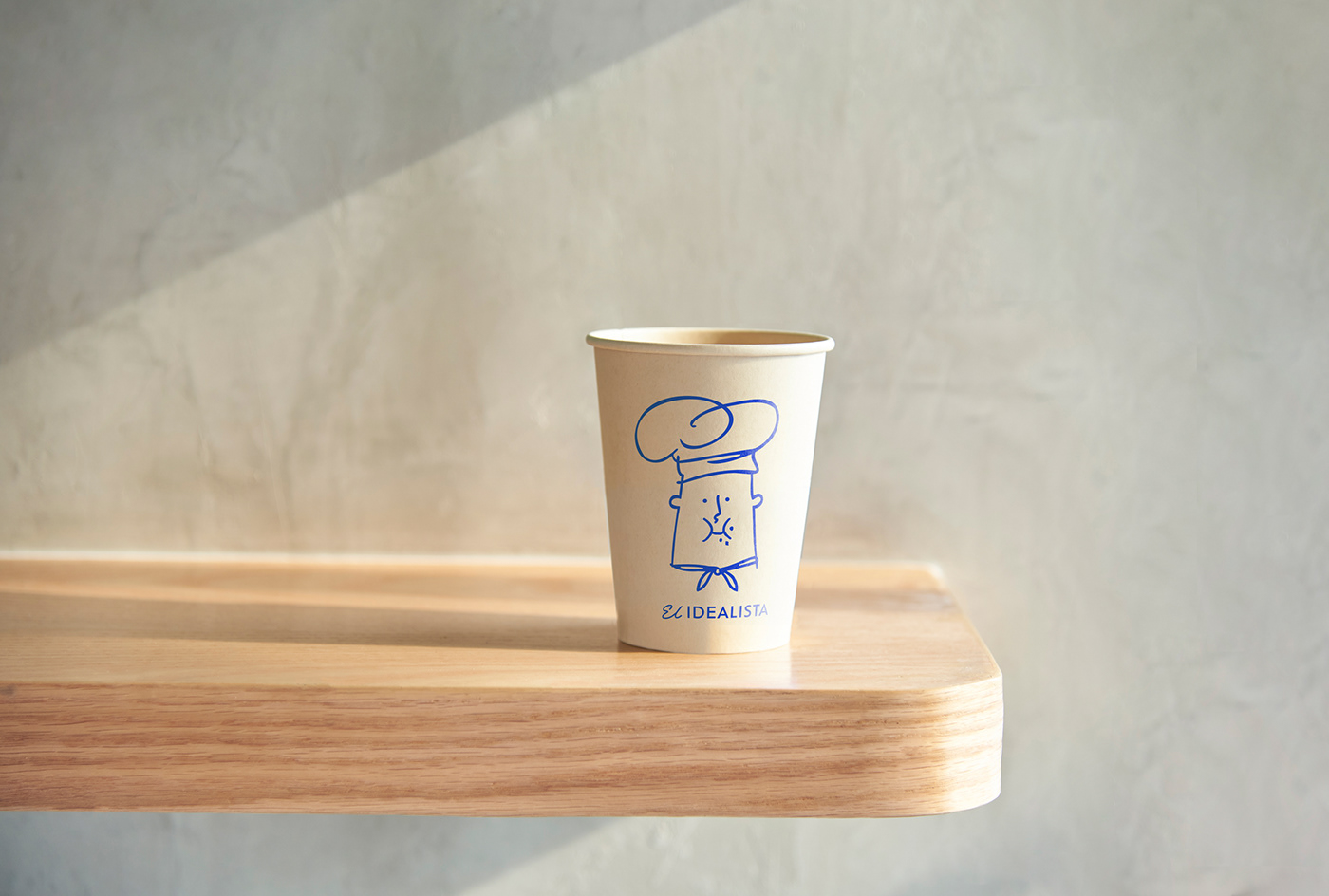 Coffee cup packaging with an illustration of El idealista
