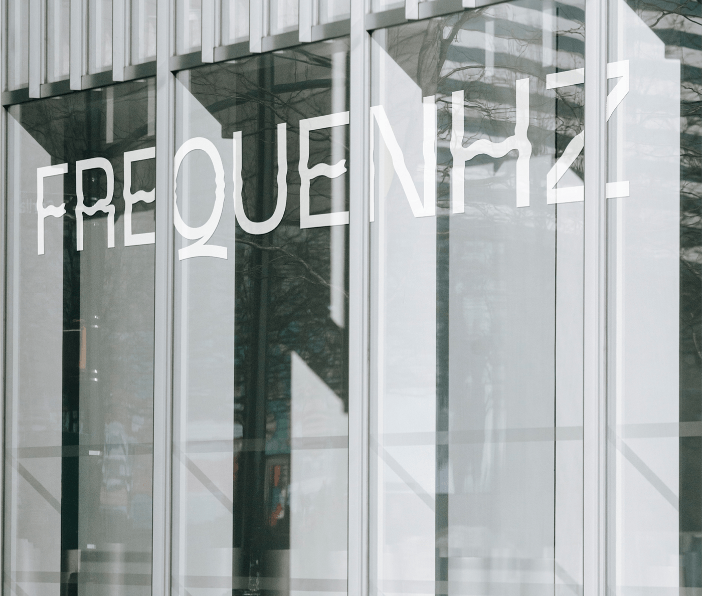 frequenhz logotype in the glass of studio front