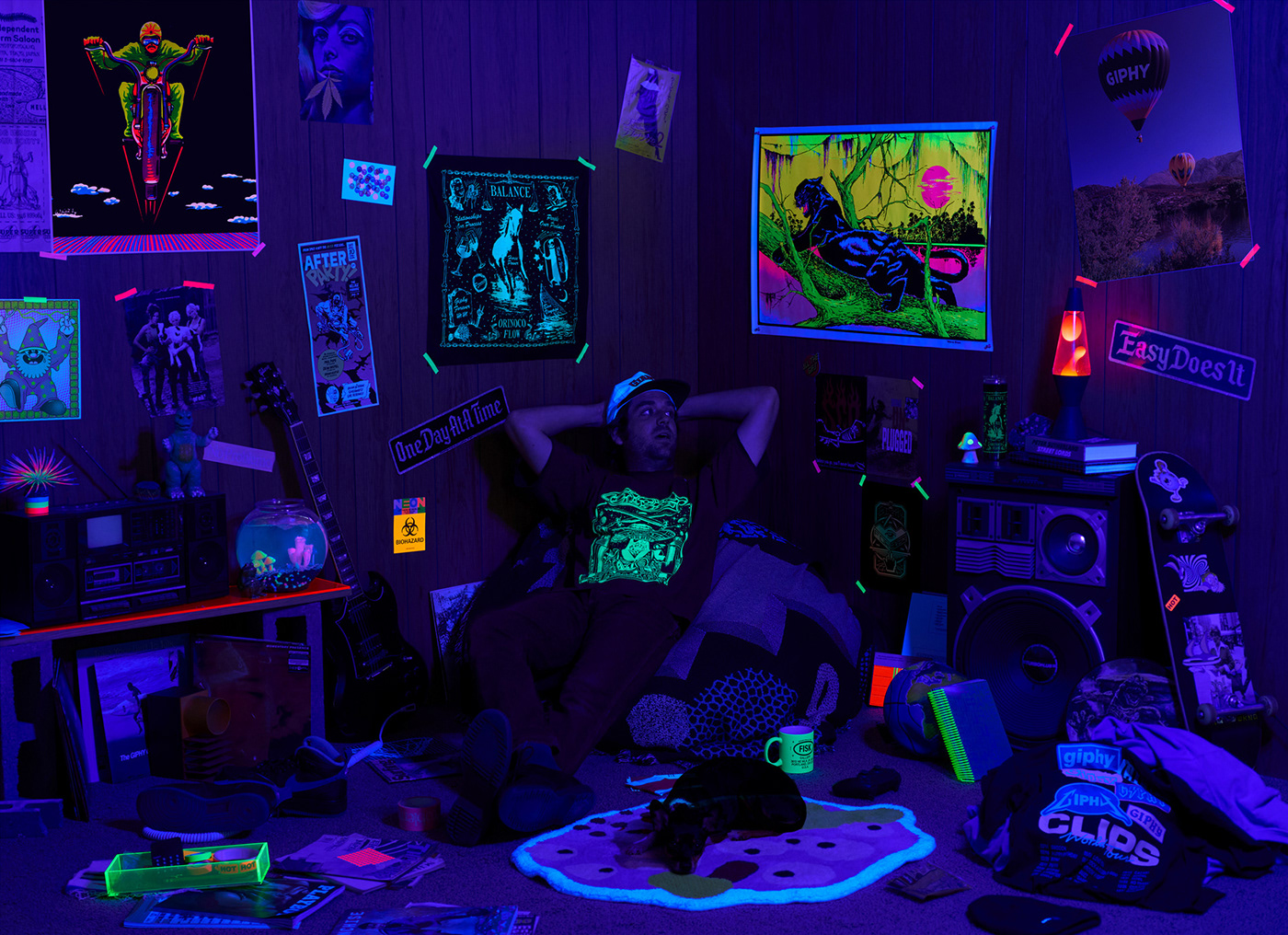 Assorted GIPHY Merchandise in context under black light