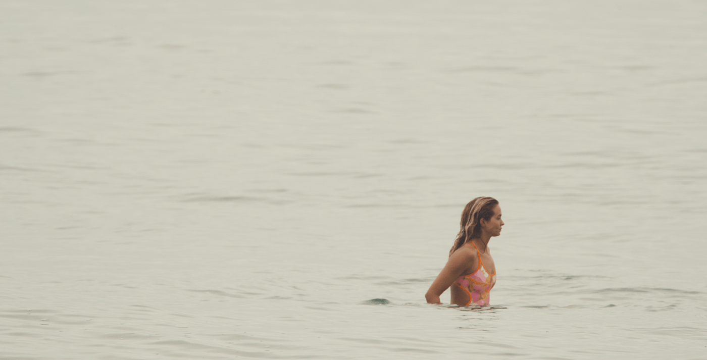 Naked girl running in water