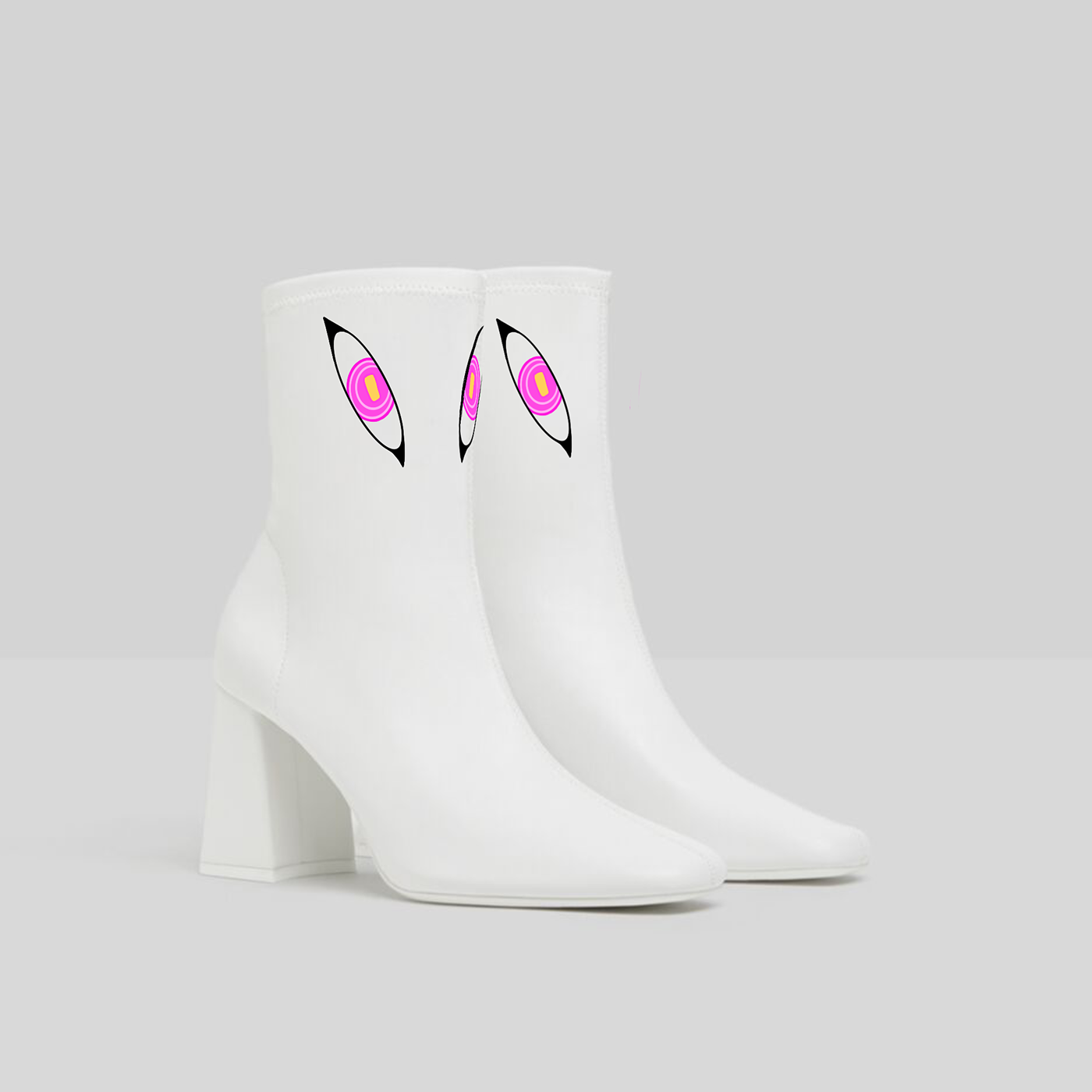 White ankle boots with pink monster eyes on it's upper part 