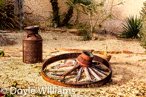 wagon wheel desert cactus Rusted iron wheel barrow rocks