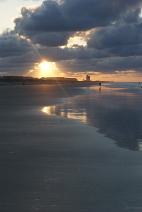 Ocean beach water Sunrise blue calm waves clouds bird photographer pier sand dunes