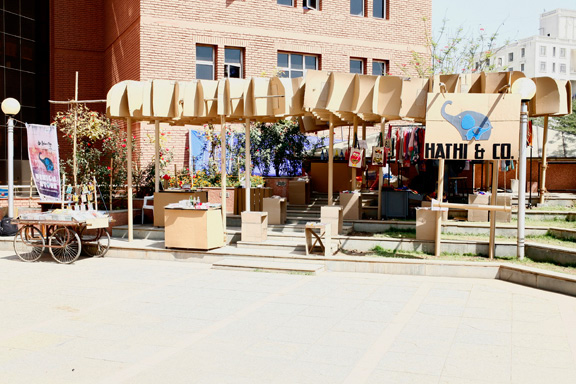 store cardboard college festival student group elephant exhibit product sale corrugated company roof canopy grid