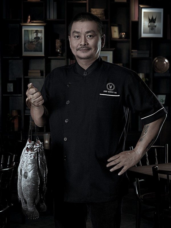 chef padang restaurant padang grill fish baramundi portrait male cooking Culinary