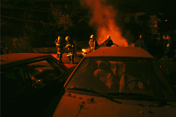 firemen fire burning car
