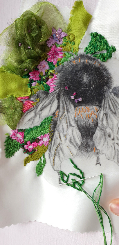 Bumblebee drawing surrounded by hand embroidery