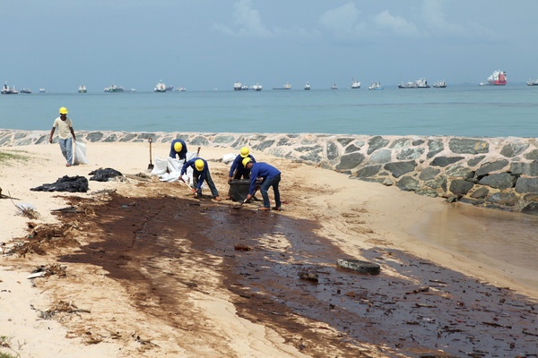 East Coast Park oil spill crude singapore South East Asia sand contaminated oil sludge beaches sea water unsung hero Workers coast line spill oil patches