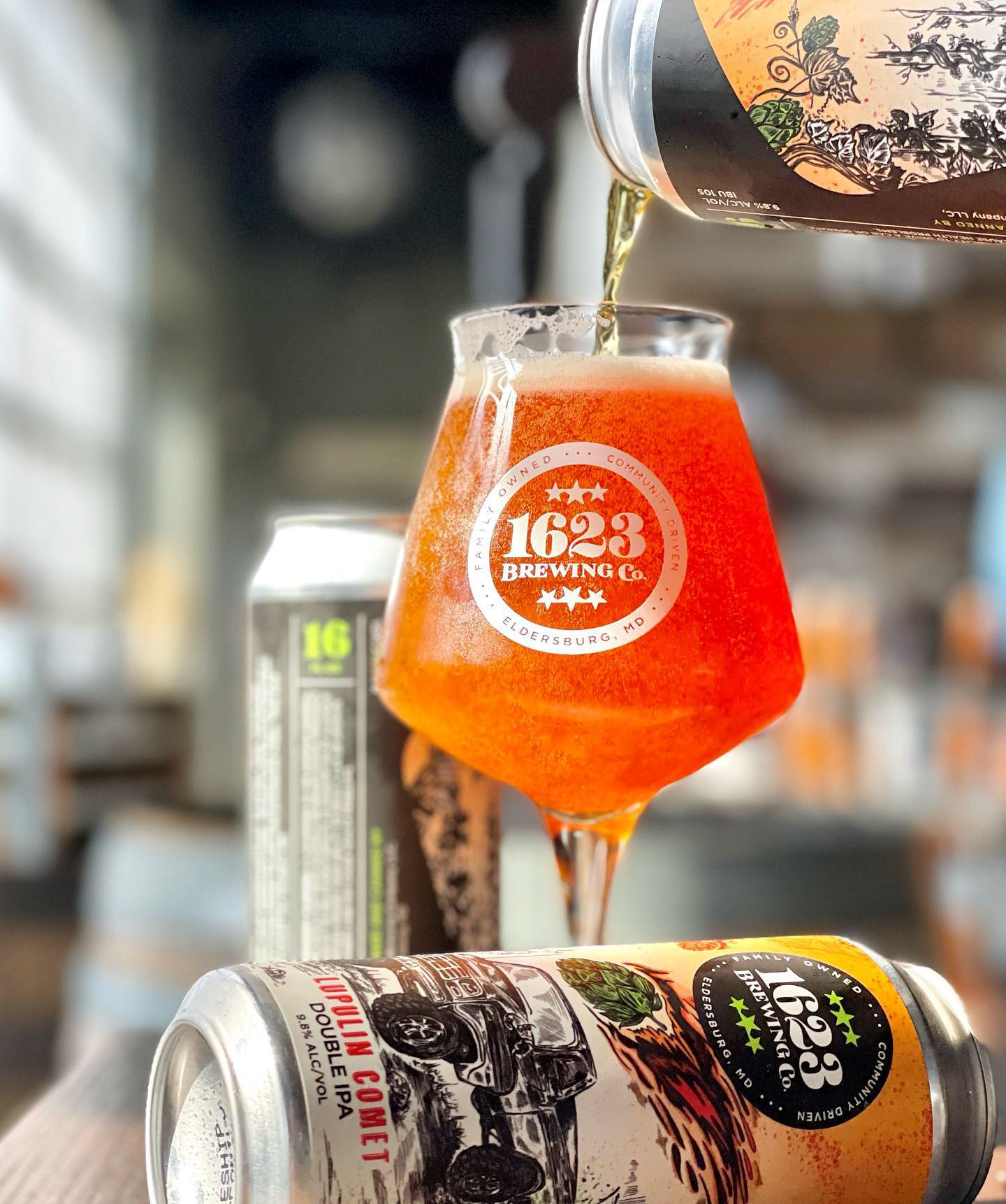 Photography of a refreshing beer being poured from a can to a glass in a brewery. 