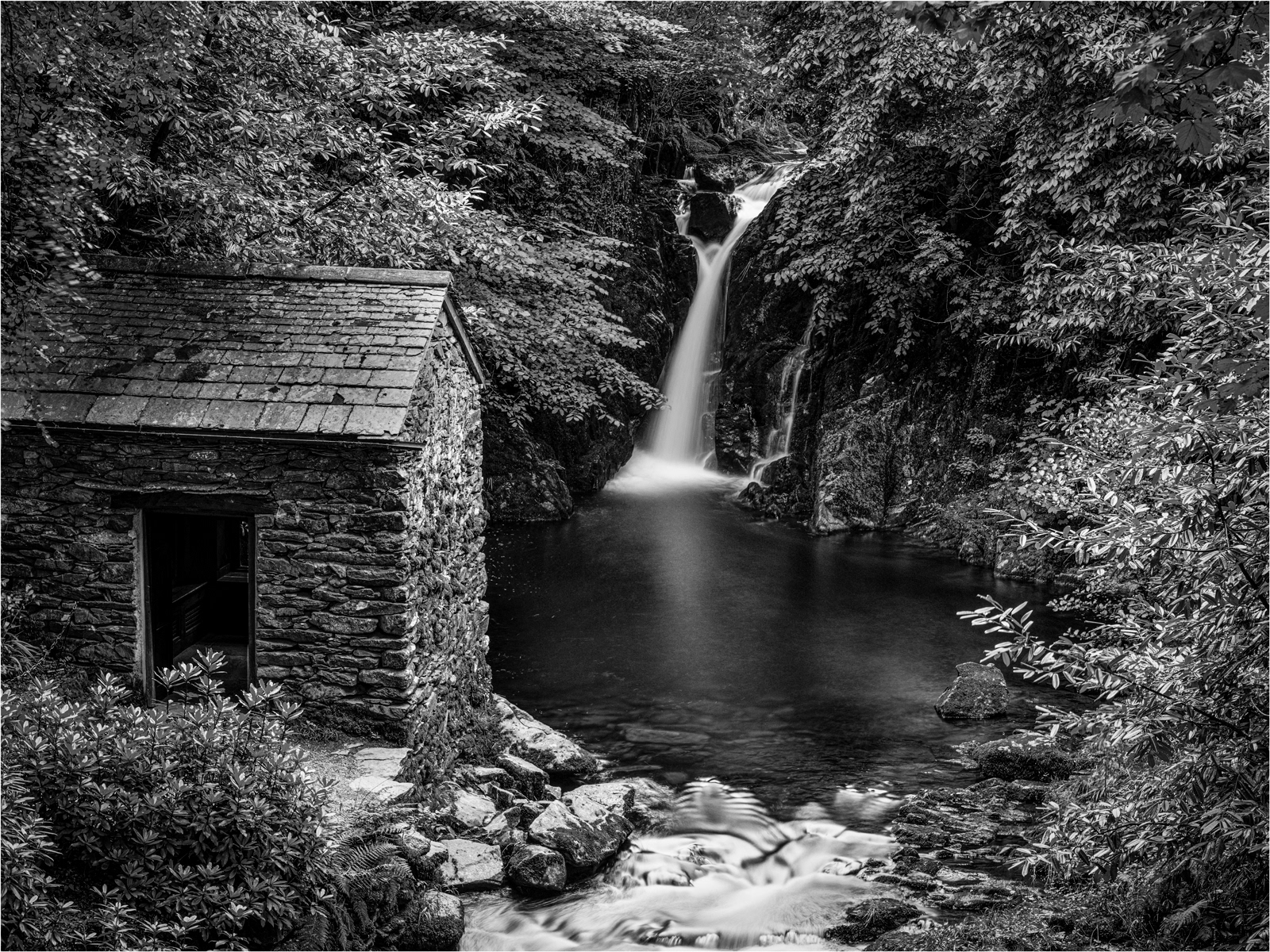 a black and white image of the Waterfall at Rydal Hall