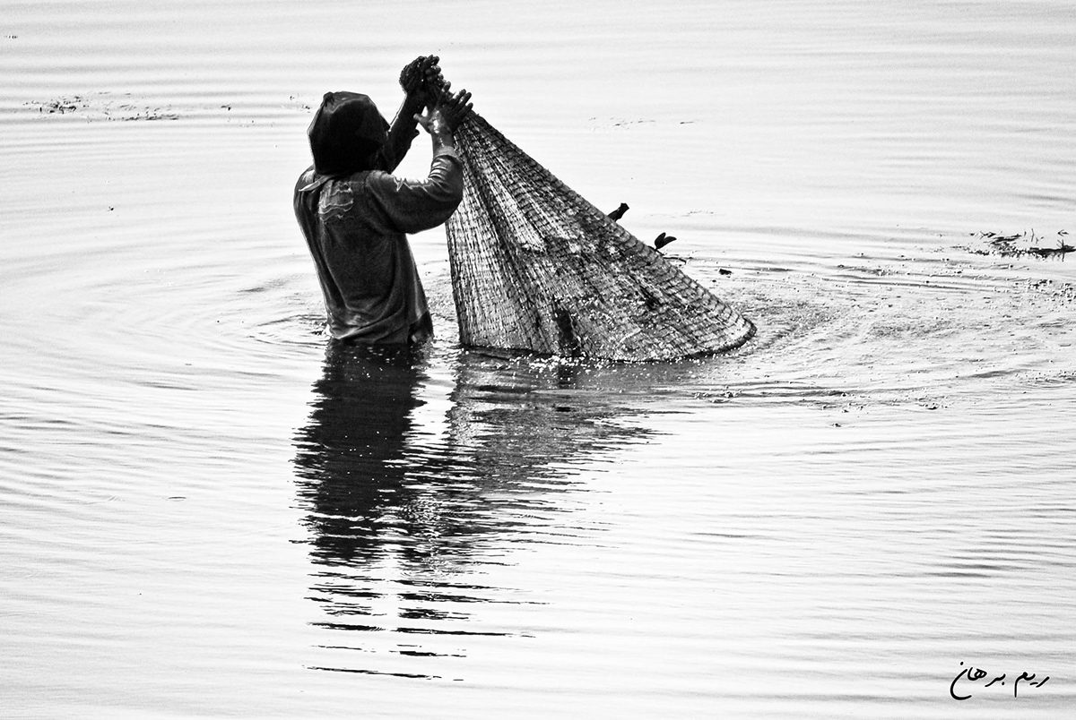 burullus lake egypt water black White red fisher man net reem borhan