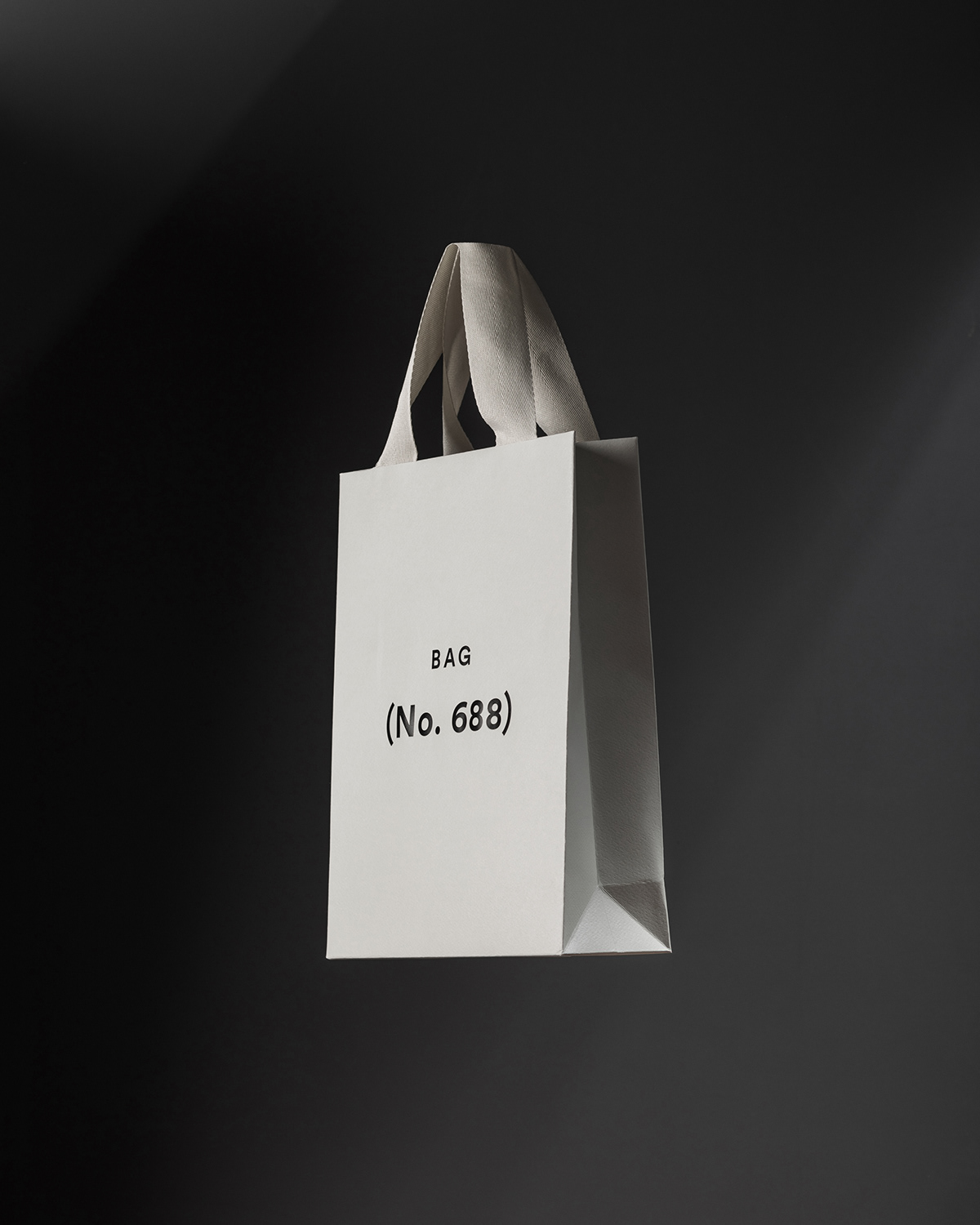 Floating cream carry bag with deboss logo in dark lit space