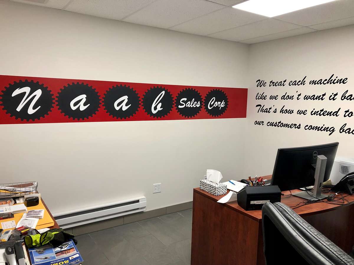 Hand painted logo and text on office wall