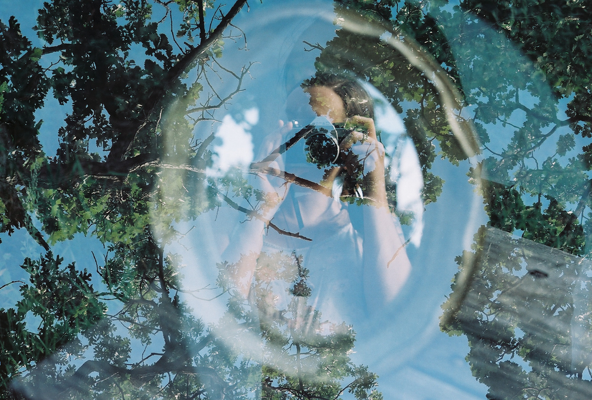 In-camera double exposure of self portrait and trees. Photographed on 35mm film with canon ae1. 