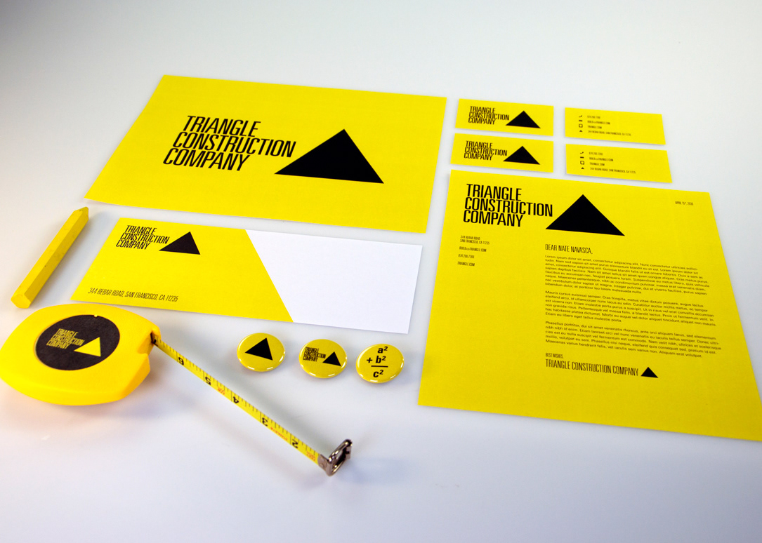 construction business card envelope letterhead pins buttons yellow triangle black print