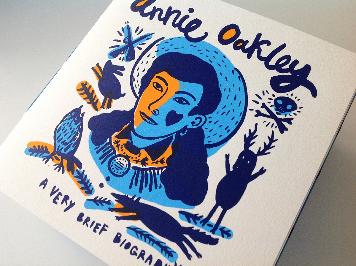 book design printmaking silkscreen limited edition blue Annie Oakley animals Hunting Gun Handlettering type buffalo bill's wild Zine  biography history
