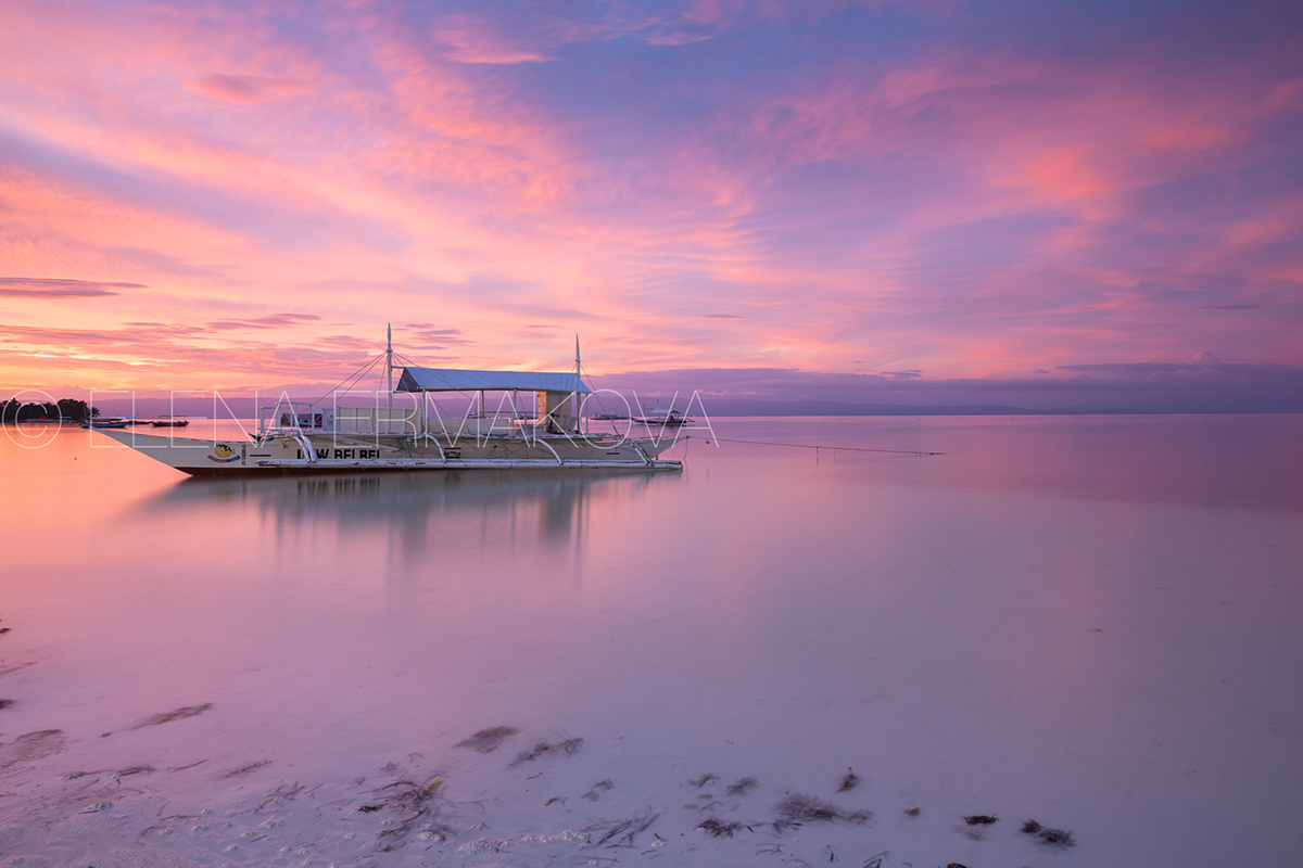 Sunset view of the Dolho Beach with traditional bangka boat, Panglao, Bohol, Philippines