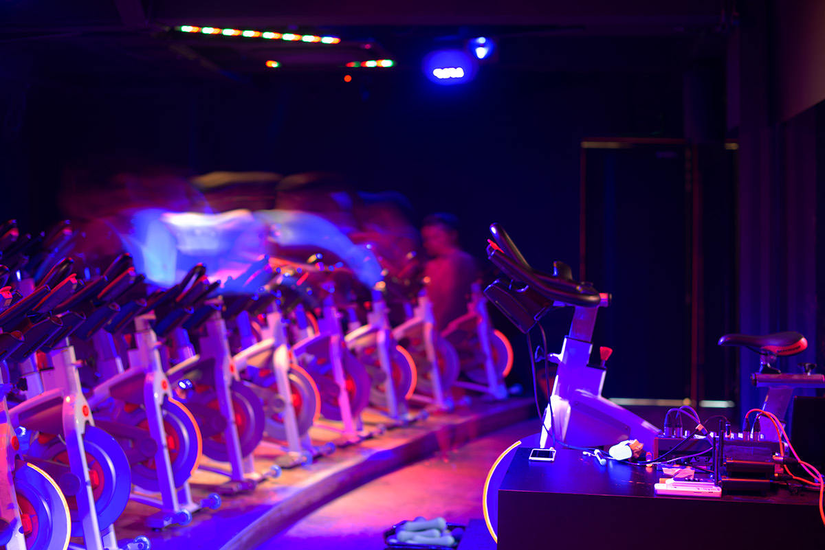 indoor cycling gym fitness neon ultraviolet 7cycle acre orange Pantone 804 shophouse singapore