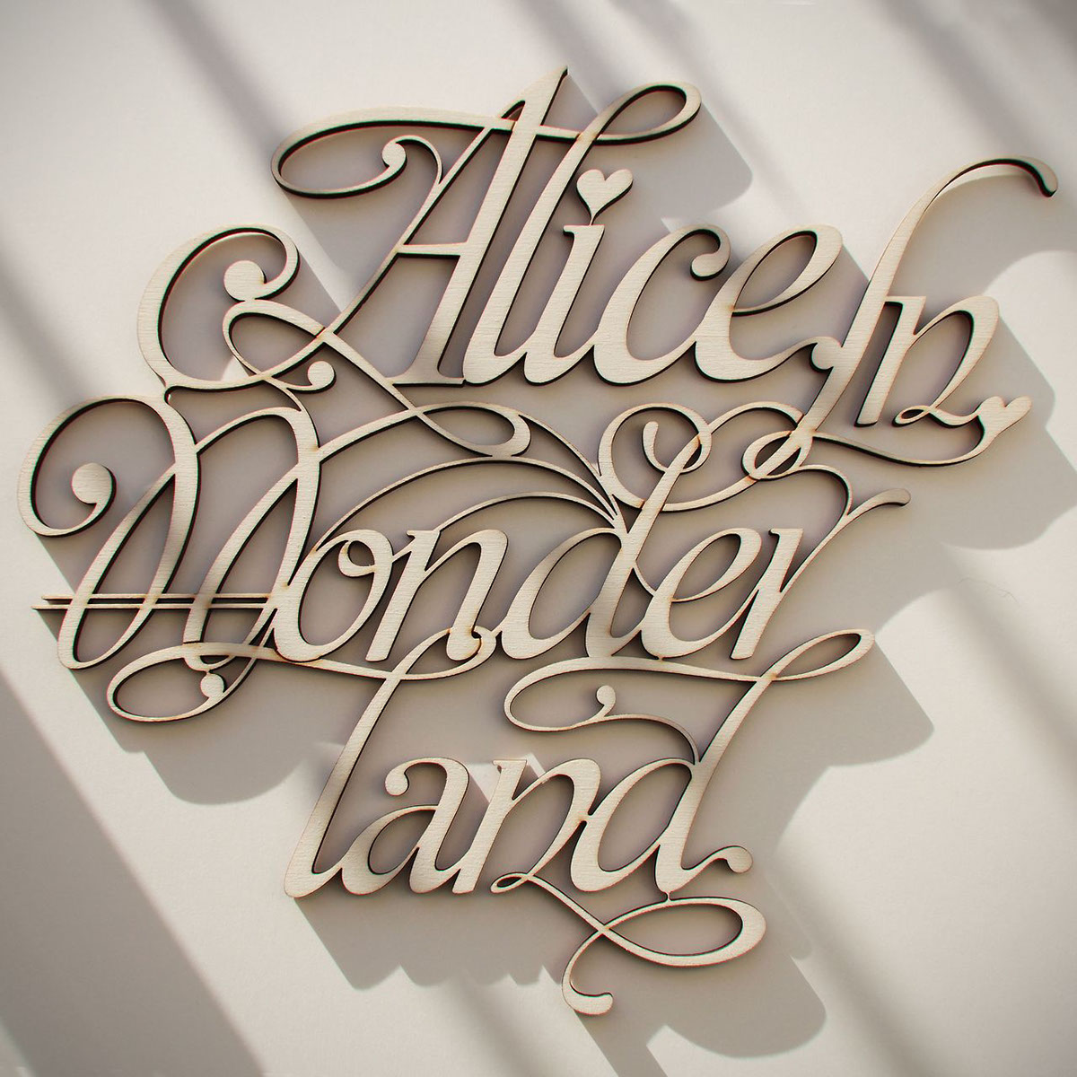 alice wonderland type lettering callygraphy ligature wood laser cut Volume