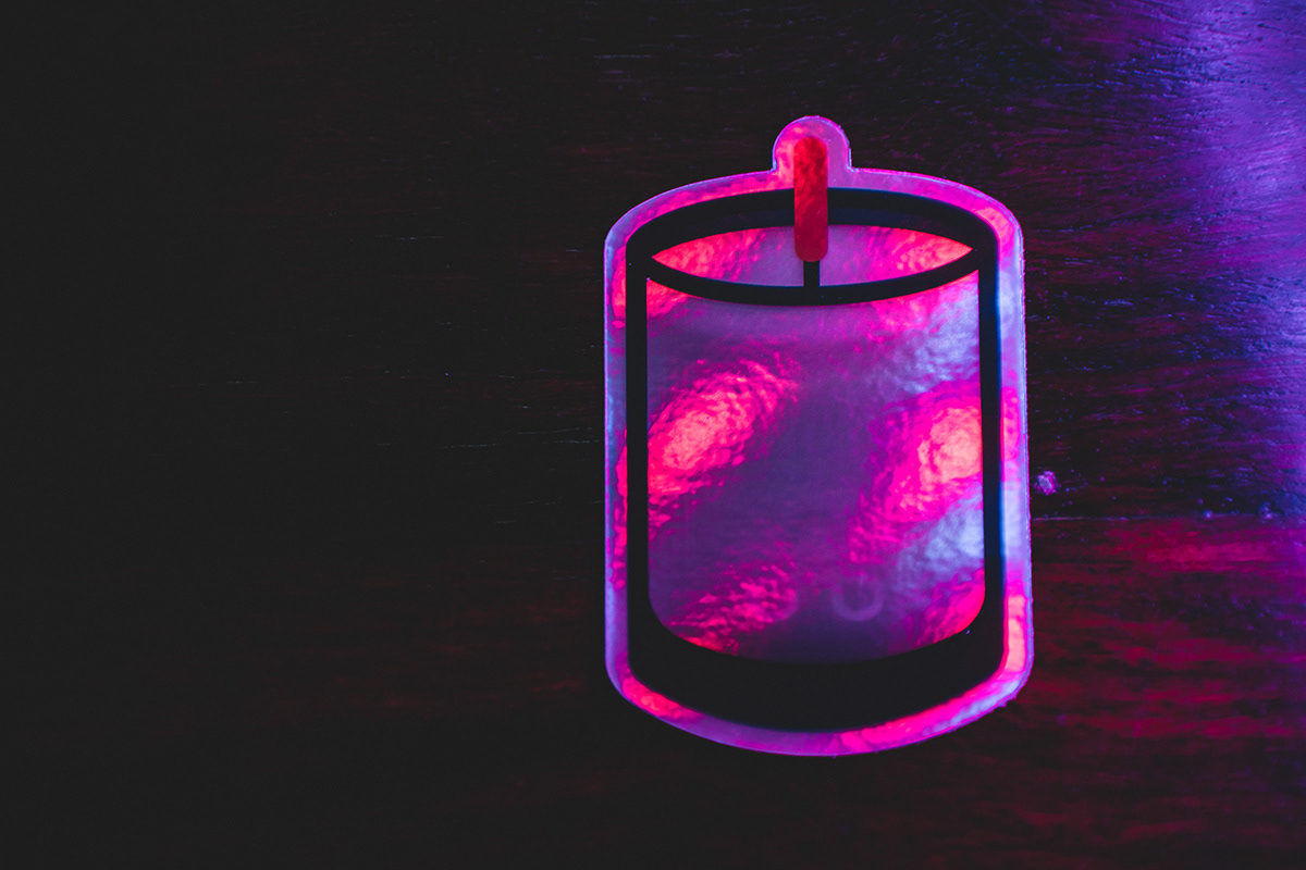 A close up shot of the Holographic Candle stickers with neon lighting