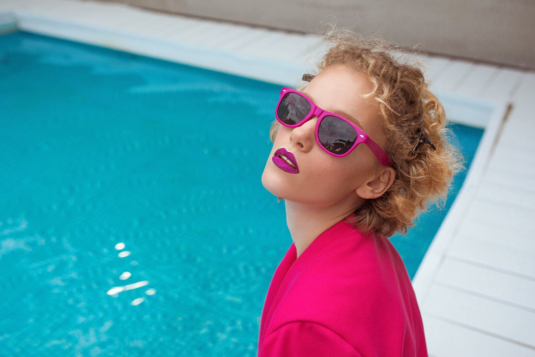 fuchsia Beautiful redhead woman Fashion  photo photographer Sunglasses lipstick swimming pool