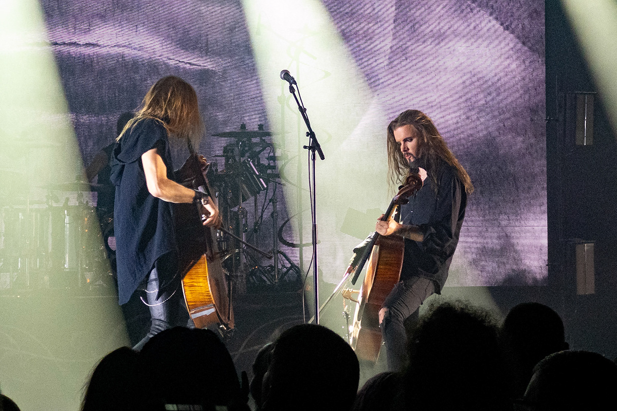 Two men playing rock/metal cello on stage