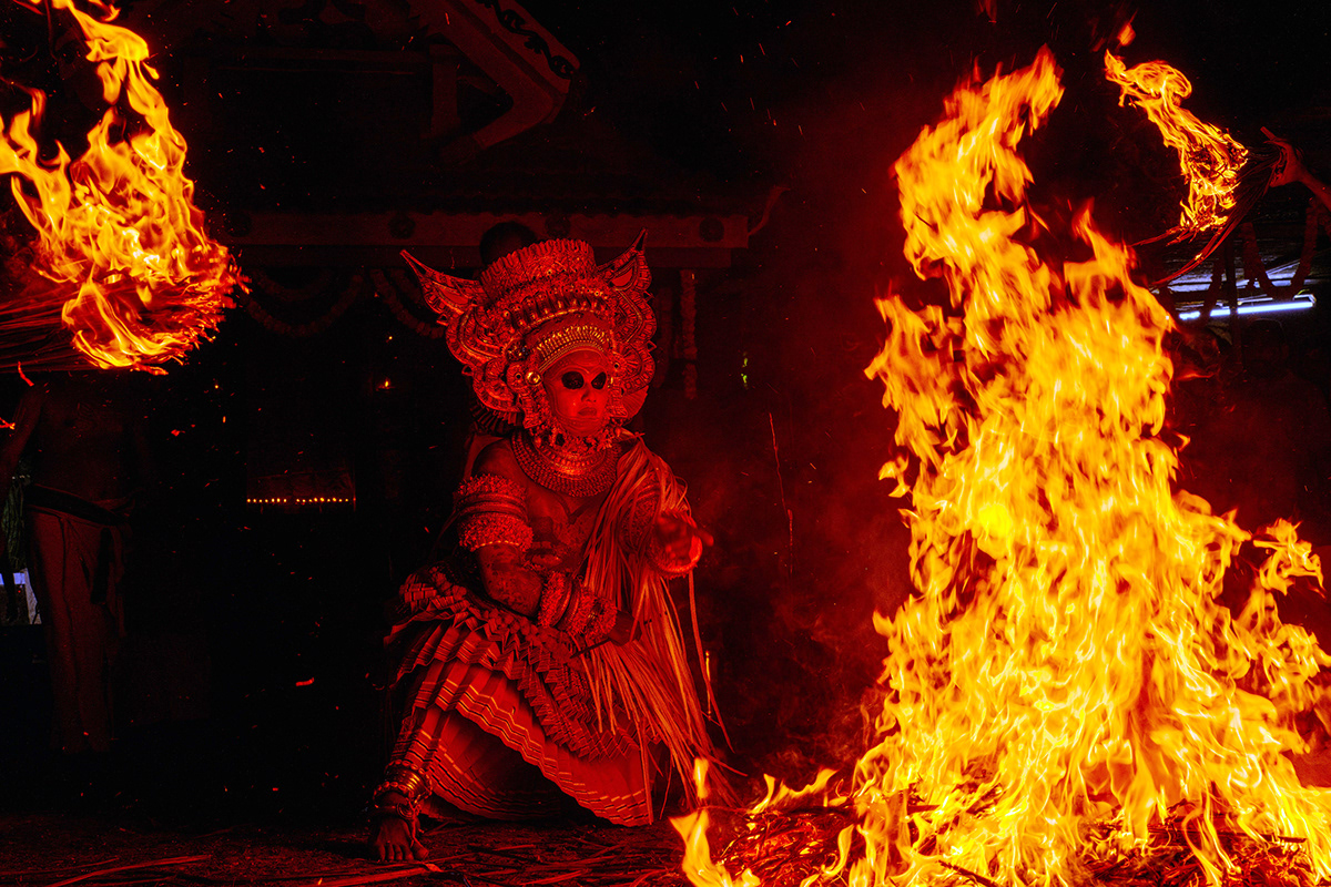 Theyyam performer speaks with fire