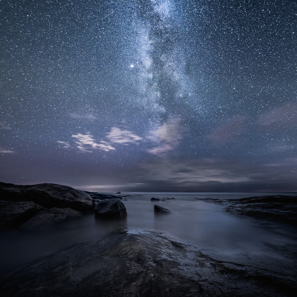 night astrophotography fine art photograph mikko lagerstedt milky way stars boat Shipwreck drifting Dreaming alone figure Silhouette beach