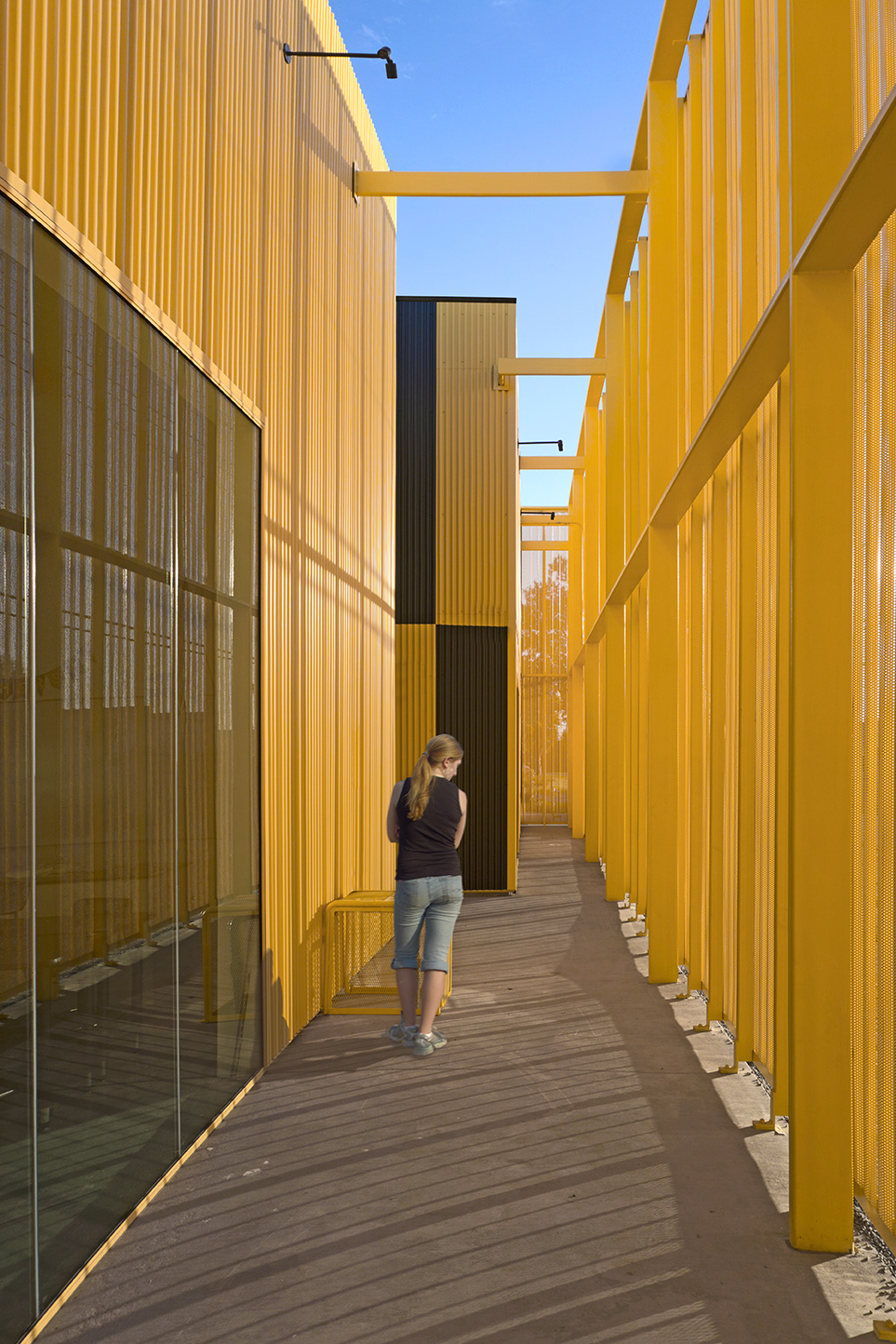 Adobe Portfolio animo south los charter high school Green Dot School lawrence scarpa perforated metal facade recycled concrete School Design Yellow school built around oil well modern school courtyard natural wool insulation perforated metal siding Yellow Building
