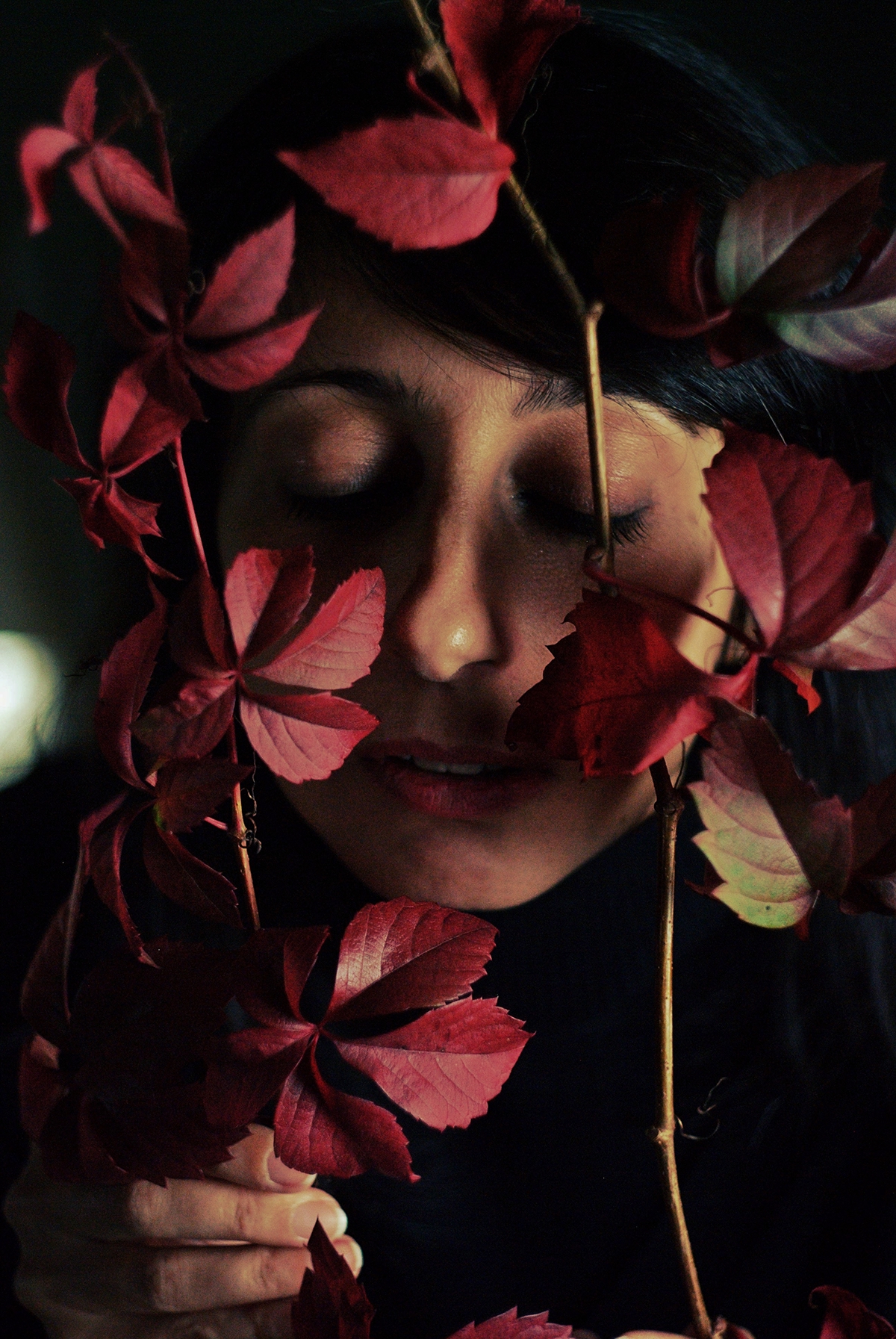 portrait woman hands red leaves autumn