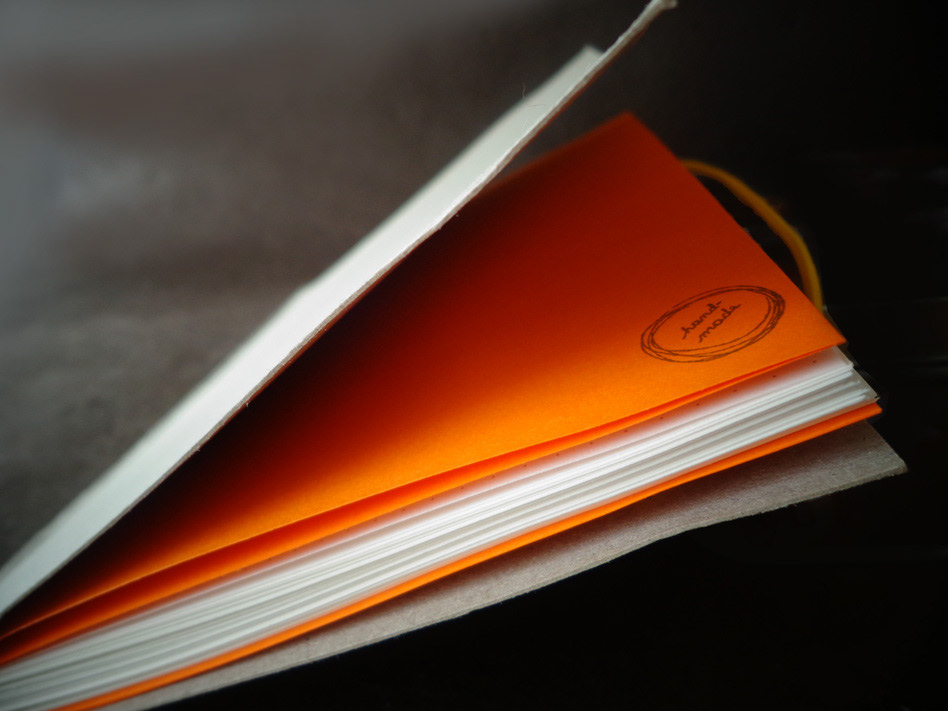 orange notebook paper Handby
