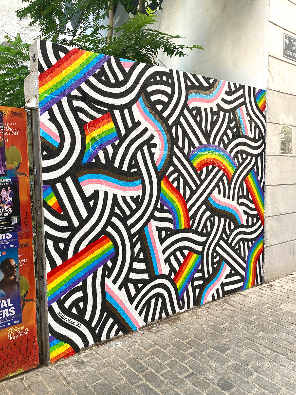 A black and white mural with the progress pride flag colors integrated, by Stillo Noir