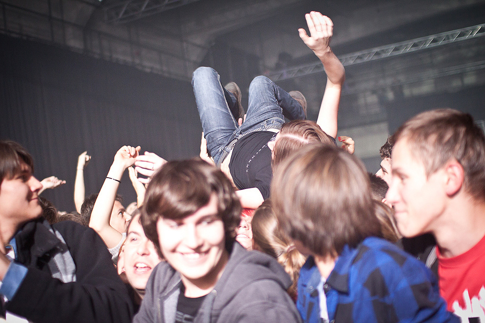 people crowd surfing concert audience