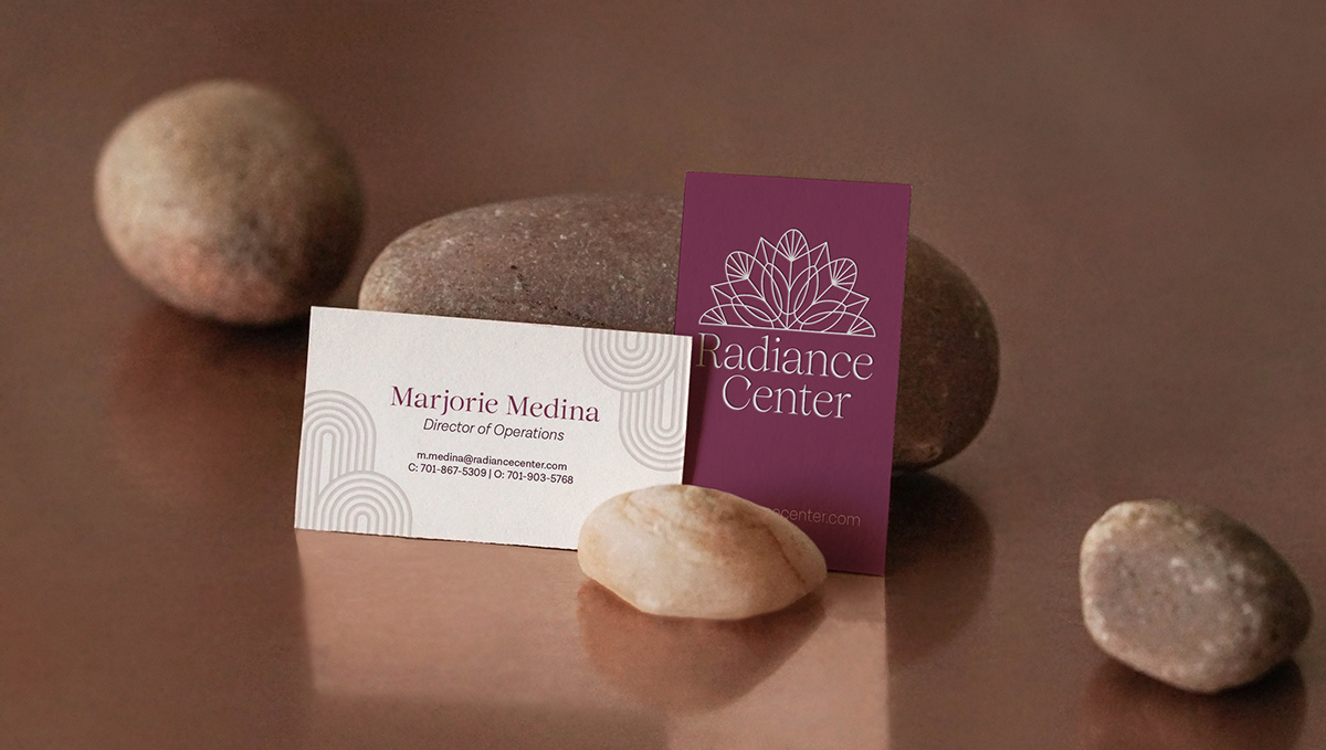 Business cards in a peaceful setting with stones and bronze