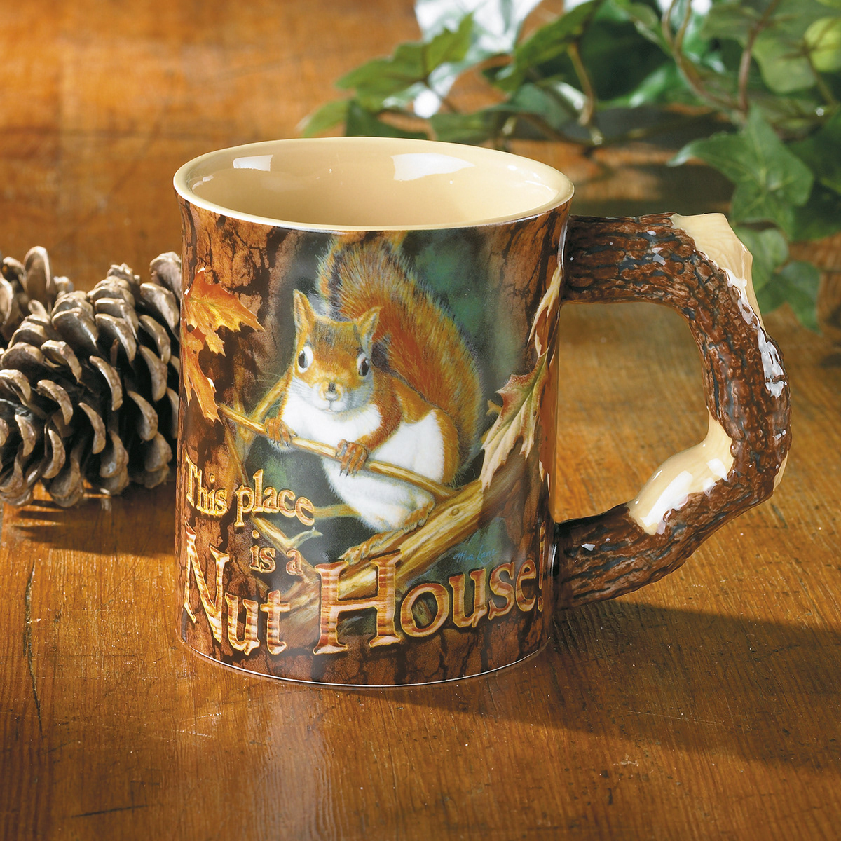 Coffee mug with handle sculpted like a tree branch and featuring a squirrel image by Mia Lane.