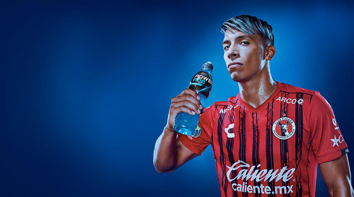 Portrait of Ángel Sepúlveda Mexico's soccer player stand with a bottle of Powerade in his hand