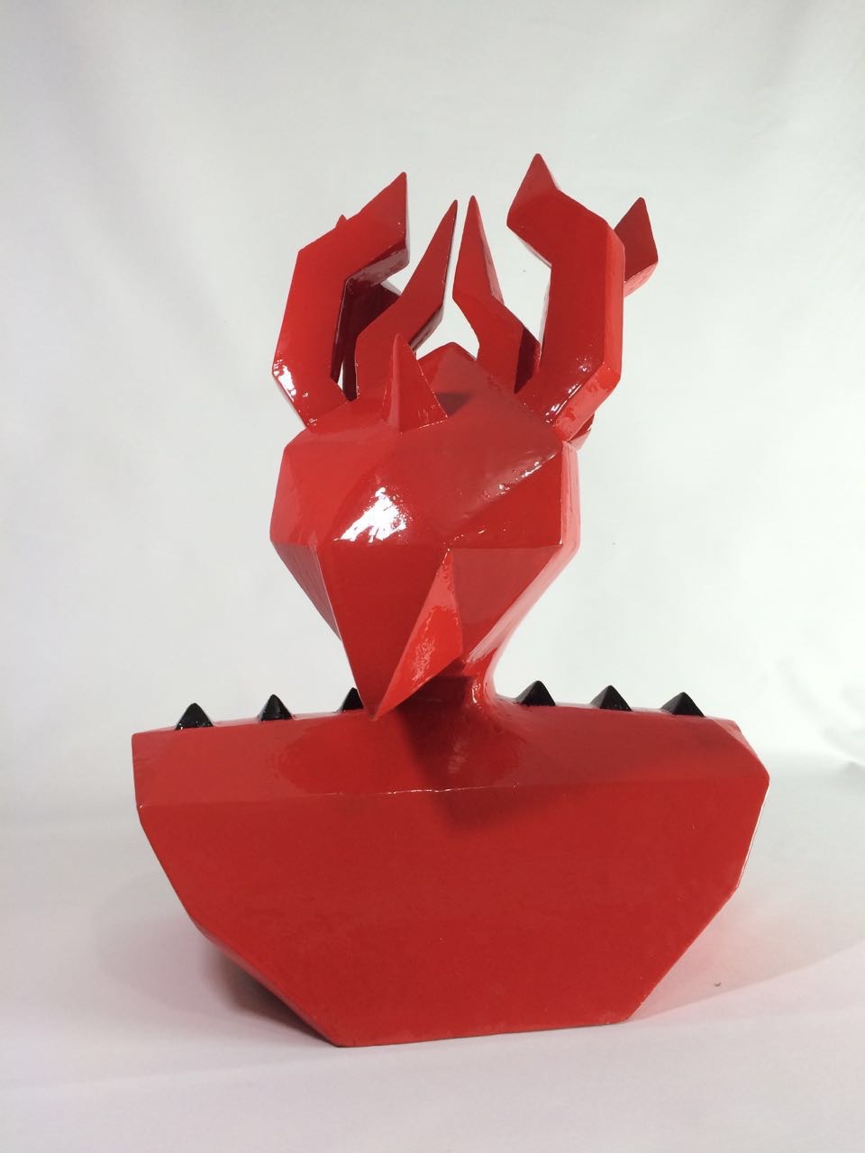 3D sculpture demon devil red shiny plastic horns Ecuador art