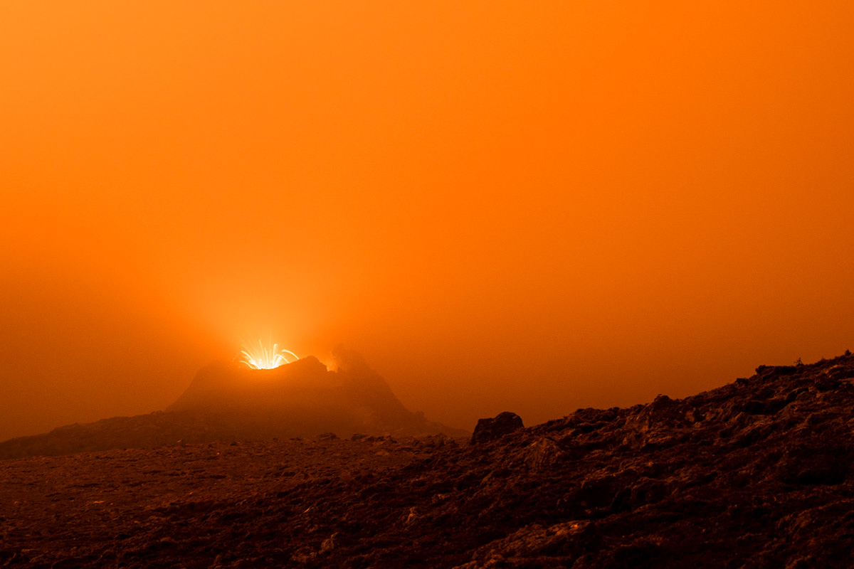 The nightly lava dips the landscape in an extraterrestrial orange