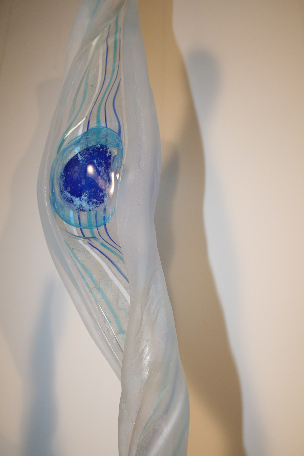 glass installation suspended hanging seaweed pods Cane spheres blue transparent Room Divider window art sculpture fluid