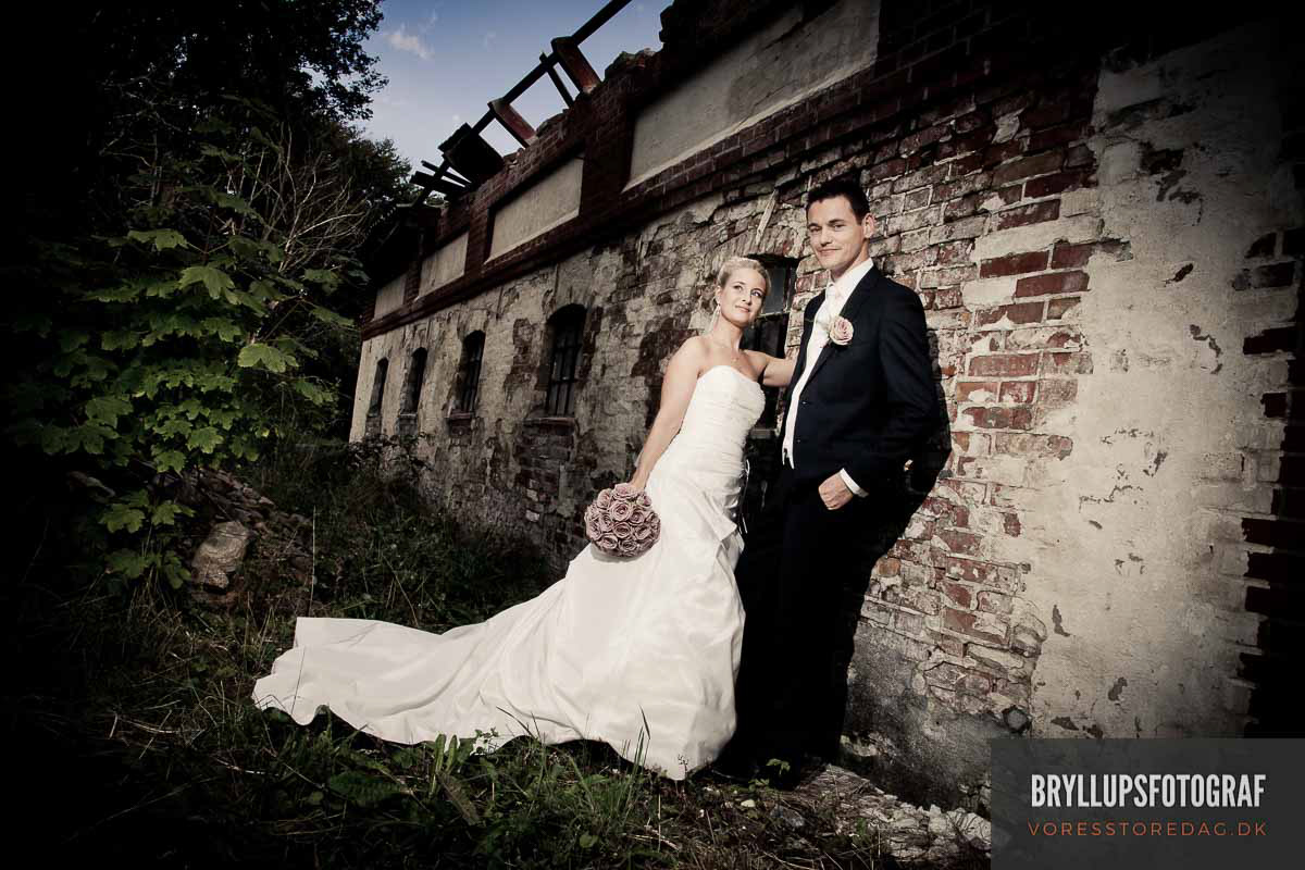Image may contain: wedding dress, building and bride