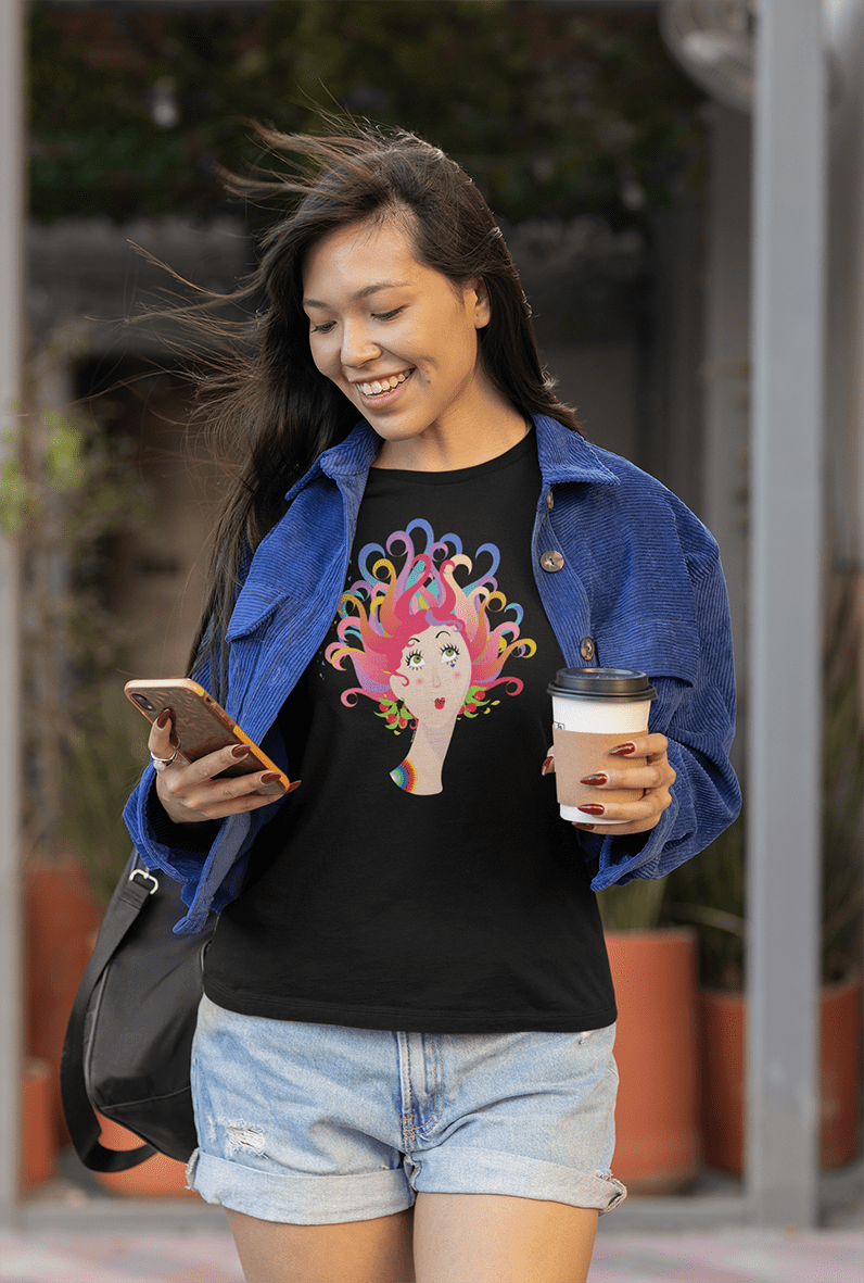 A young woman walking, dressed with a black T-shirt with a graphic colourful illustration